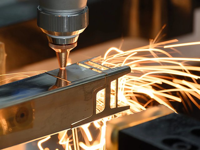 CNC laser cutting close-up with sparks